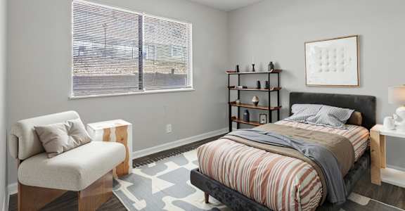 A bedroom with a bed, chair, and shelves.