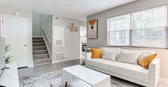 a living room with a couch and a table at The Cobb Apartments-Townhomes, Austell, Georgia
