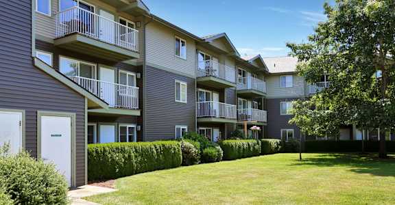 Apartment complex with a green lawn in front at VINTAGE AT BELLINGHAM, Bellingham, WA