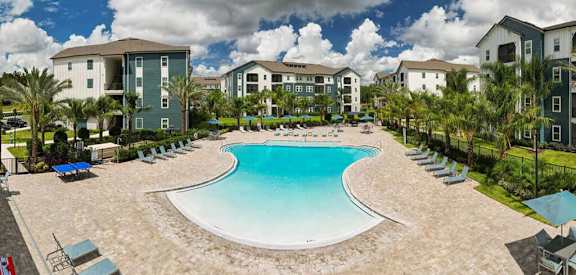 an aerial view of a resort style pool with lounge chairs and umbrellas at Fountainhead, Jacksonville, Florida, 32258