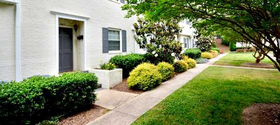 a white house with a sidewalk in front of it at Midtown Park Townhomes, Raleigh, 27609