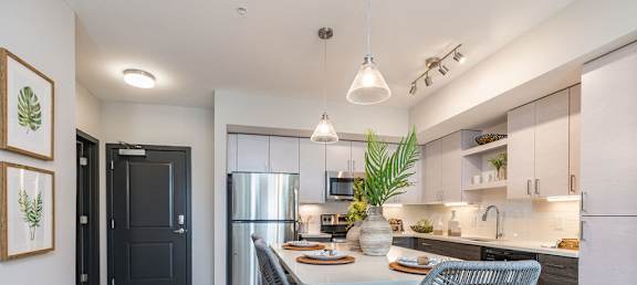 A modern kitchen with a dining table and chairs.