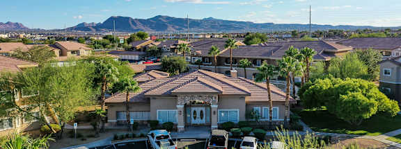 A residential area with houses and cars parked in front.