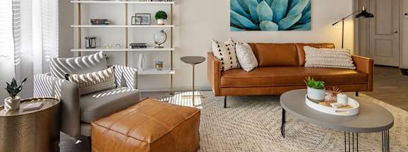 a living room filled with furniture and a painting of a succulent at Element Deer Valley, Phoenix, Arizona