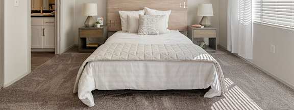 a bedroom with a bed and a door to a bathroom at Element Deer Valley in Phoenix, AZ