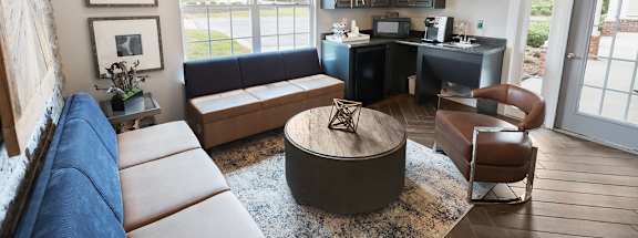 A modern living room with a large sectional sofa and a coffee table.