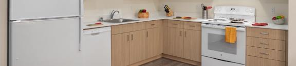 A kitchen with a white refrigerator and white stove.