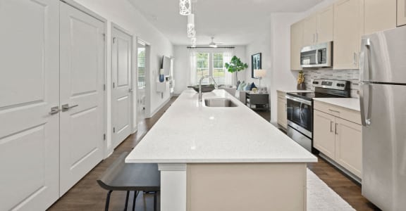 a large white kitchen with a white counter top
