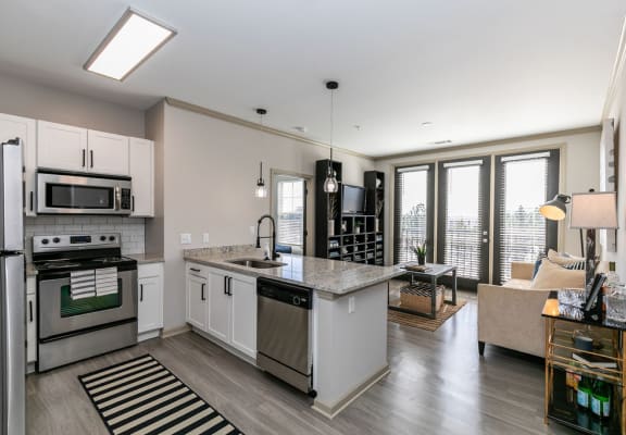 an open kitchen and living room with a view of the city