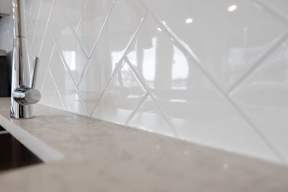 A close up of a sink with a silver faucet.