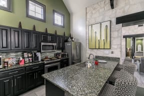 Community kitchen with stainless steel appliances and serving bar