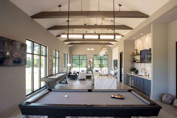 a pool table in the center of a living room