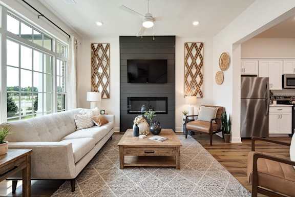 A modern living room with a fireplace and a television.