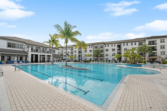 a large swimming pool with buildings in the background at Inspira, Florida, 34113