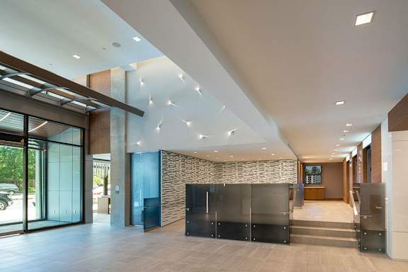 A modern interior with a glass wall and a stone wall at Artline Apartments, Washington, DC, 20024