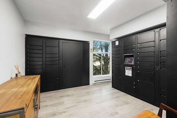 a room with lockers and a table and a window