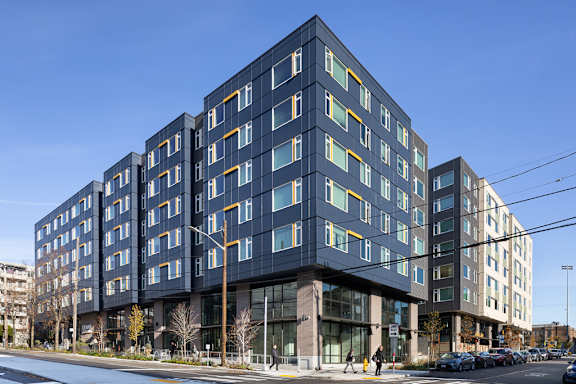 a large apartment building with stairs and a sidewalk at Cedar Crossing, Seattle, WA, 98115