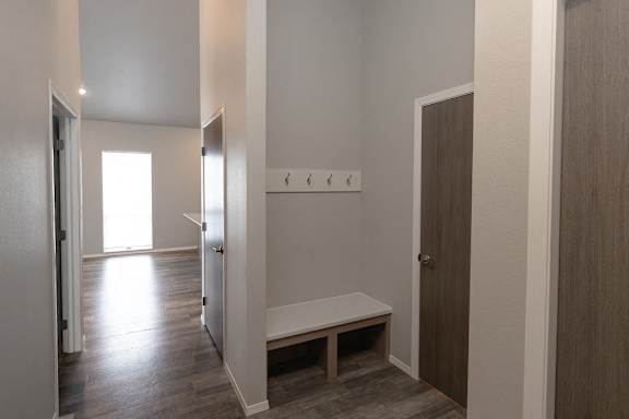 A room with a bench and a door.