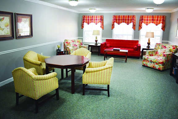 a living room with couches and chairs and a table