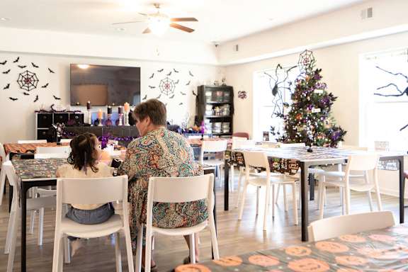 a mother and daughter sitting at a table in a restaurant