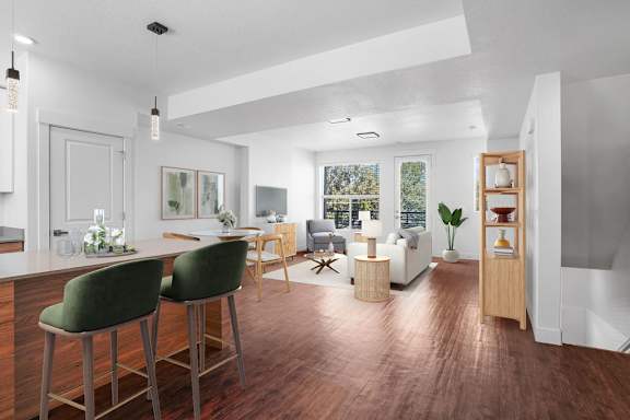 A modern kitchen with green barstools and a wooden island.