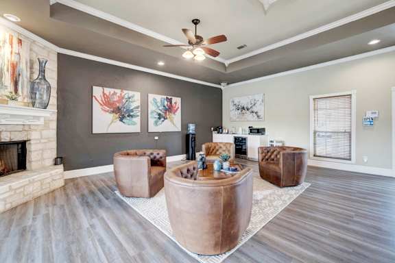A living room with a fireplace and a painting on the wall.