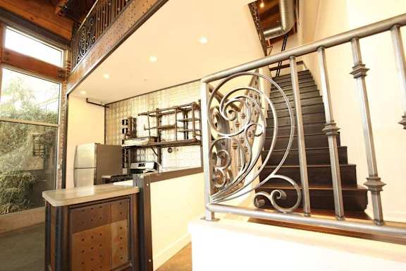 a spiral staircase in a house with a kitchen