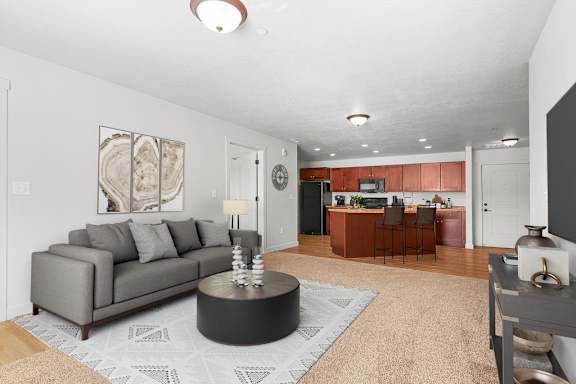 A kitchen with brown cabinets and black appliances.