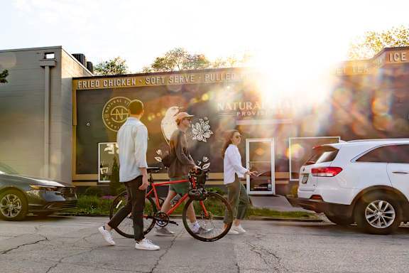 Friends with bikes walking at Gathyr Apartments, Indianapolis