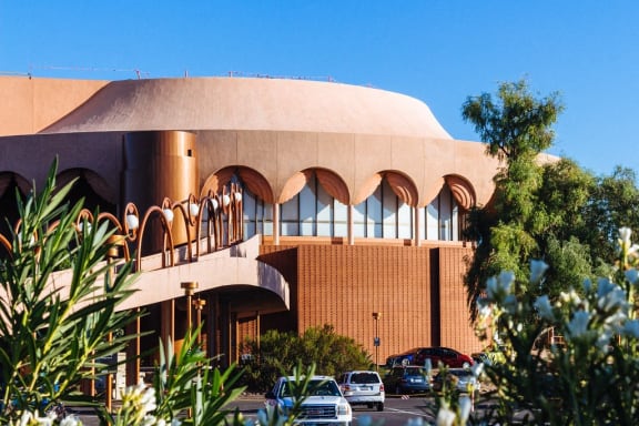 a large building with cars parked in front of it