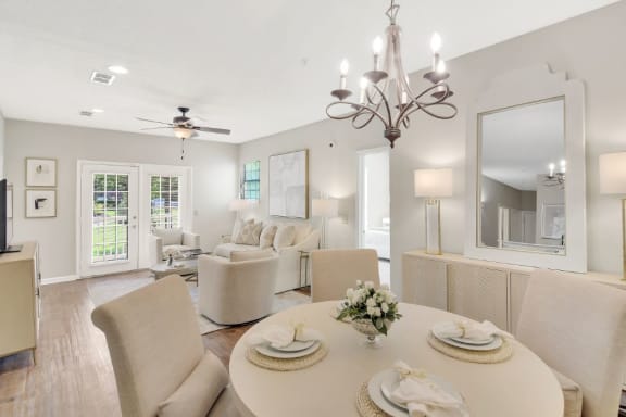 a rendering of a living room with a kitchen in the background at Legacy Apartment Homes, Ridgeland, 39157