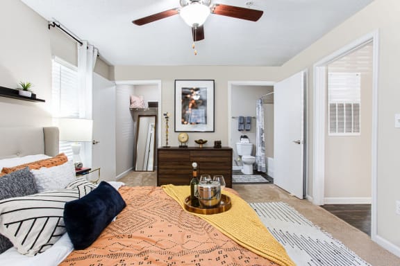 a bedroom with a bed and a ceiling fan at Indigo Apartments Gainesville, Gainesville, GA