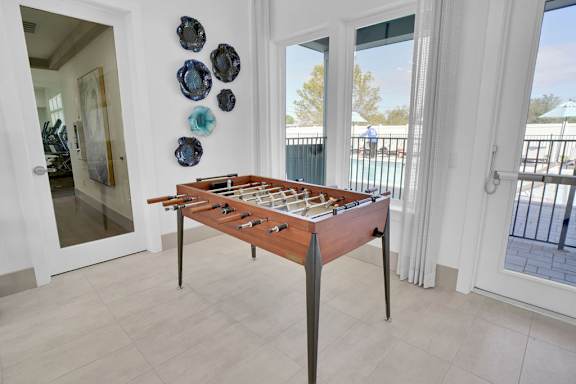 A shiny wooden table with a checkerboard pattern on it.