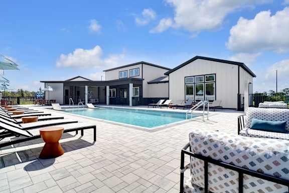 A modern house with a pool in the backyard.