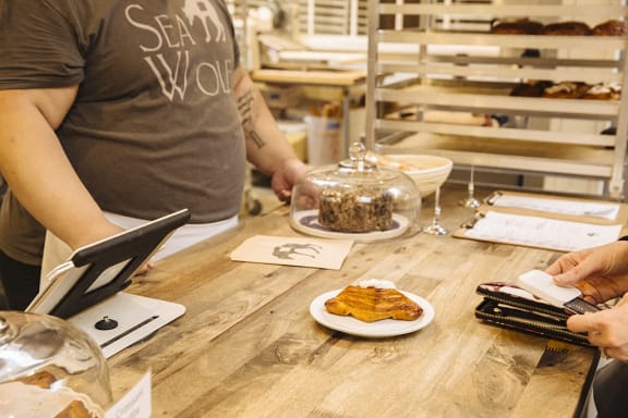 a person sitting at a table with a plate of food at The Hayes on Stone Way, Seattle, WA, 98103