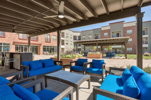 Westlake Greens blue patio furniture with brown metal awning above it
