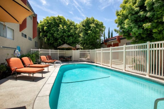 West Hills Apartments for Rent - Topanga Canyon - Exterior View of Gated Pool with Lounge Chairs and Dining Table