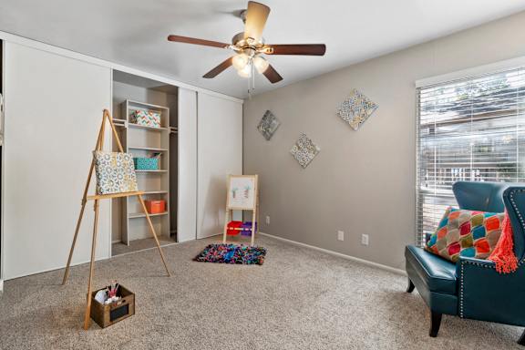 Spacious room with ceiling fan and built in storage at The Colony Apartments, Universal City, Texas