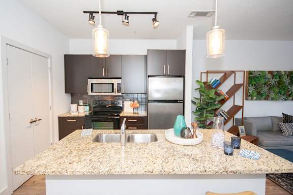 a kitchen with stainless steel appliances and granite counter tops at Glenwood Park Lofts, Atlanta, GA, 30316
