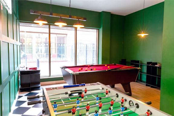a games room with a pool table and foosball