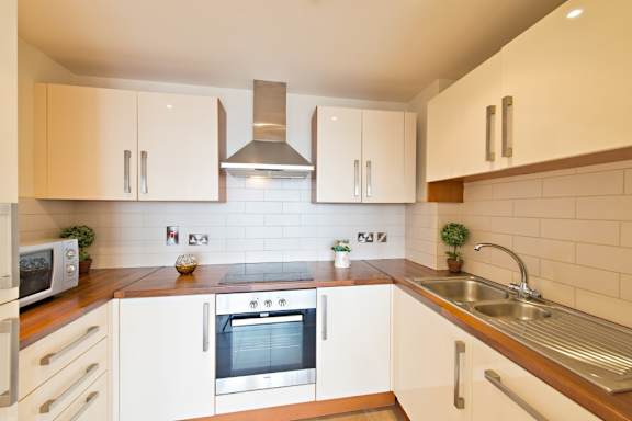 a kitchen with white cabinets and a sink