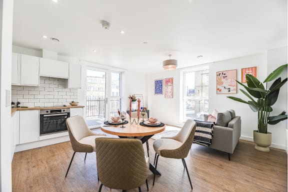 A modern dining room with a table set for four.