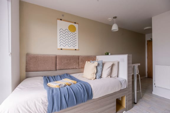 a bedroom with a bed and a desk