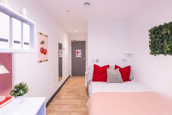 a bedroom with a bed and a door to a bathroom