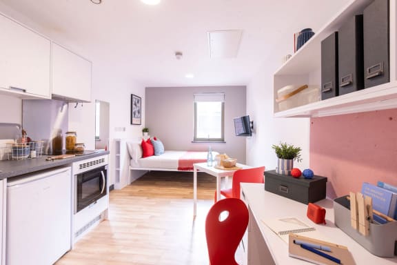 a kitchen and a living room with a table and a couch