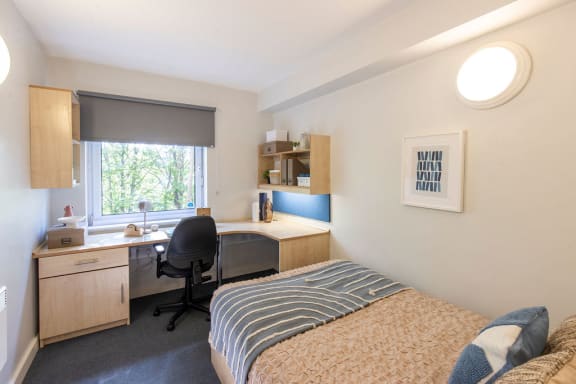 a room with a bed and a desk in it