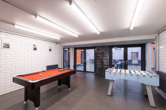 a games room with a pool table and foosball