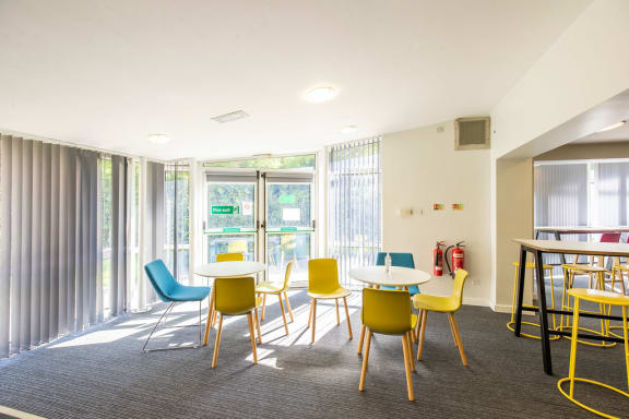 a seating area with tables and chairs