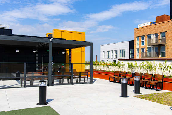 a terrace with tables and chairs outside of a building