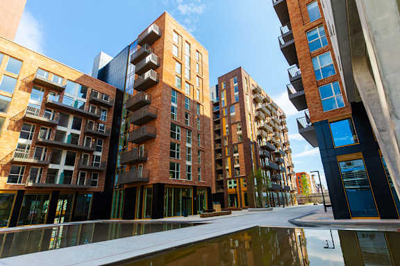 a row of modern buildings with a reflecting pool